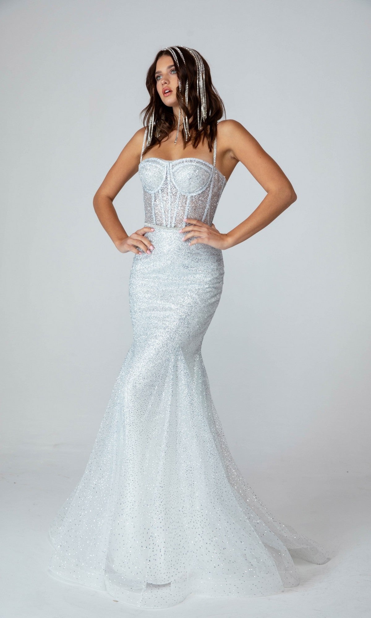 A woman in the silver Eureka 9911 long prom dress, featuring a glitter corset bodice and an elegant mermaid silhouette.